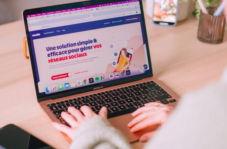 Someone is typing on a laptop with a website open.